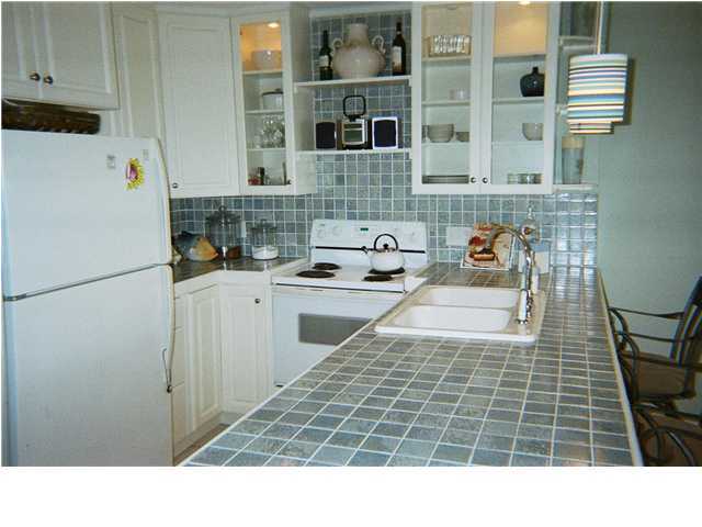 8294 Hwy Inlet Beach, Unit 7 30A Inlet Beach, FL 32461 - Photo 5 of 8 a kitchen with a sink and a refrigerator