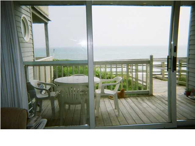 8294 Hwy Inlet Beach, Unit 7 30A Inlet Beach, FL 32461 - Photo 8 of 8 a balcony with table and chairs