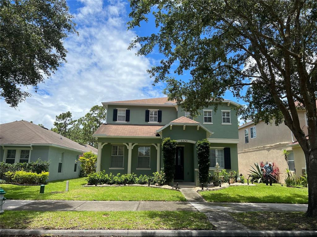 2570 Wild Tamarind Boulevard Orlando, FL 32828 - Photo 1 of 20 a front view of a house with garden