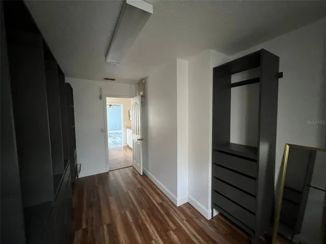 a view of hallway with wooden floor