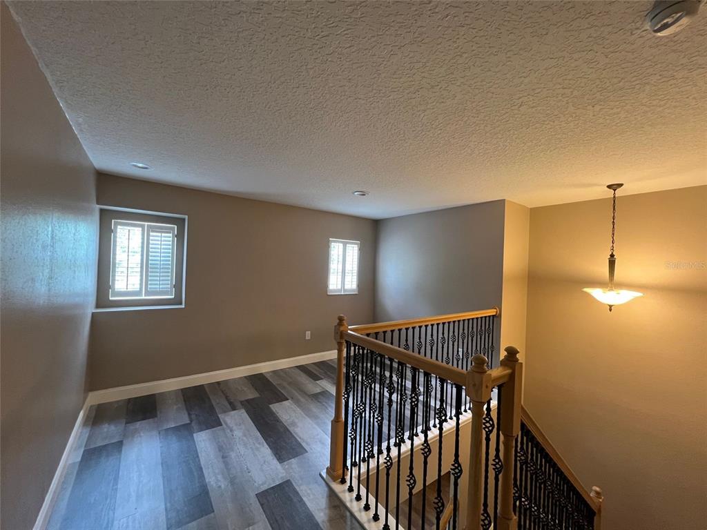 2570 Wild Tamarind Boulevard Orlando, FL 32828 - Photo 13 of 20 a view of hallway with window and wooden floor
