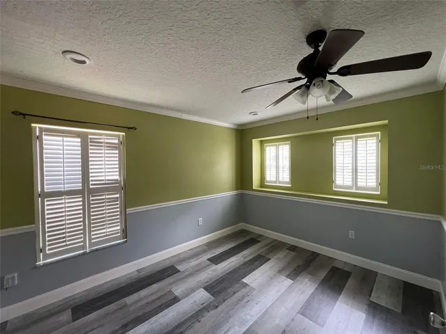 a view of room with window and ceiling fan