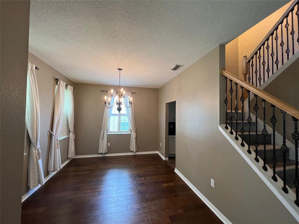 2570 Wild Tamarind Boulevard Orlando, FL 32828 - Photo 2 of 20 a view of entryway and hall with wooden floor