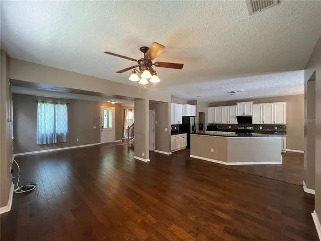 a view of kitchen with sink microwave and stove