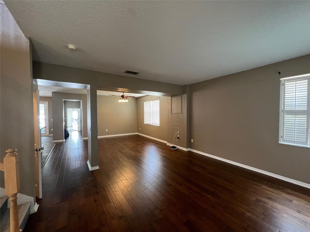 2570 Wild Tamarind Boulevard Orlando, FL 32828 - Photo 8 of 20 an empty room with wooden floor and windows