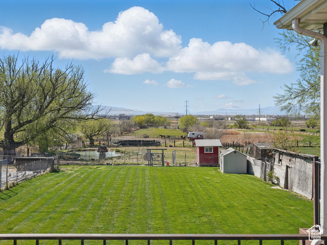 2490 South State Street Springville, UT 84663 - Photo 17 of 38 View of yard with an outdoor structure, a storage unit, and a fenced backyard