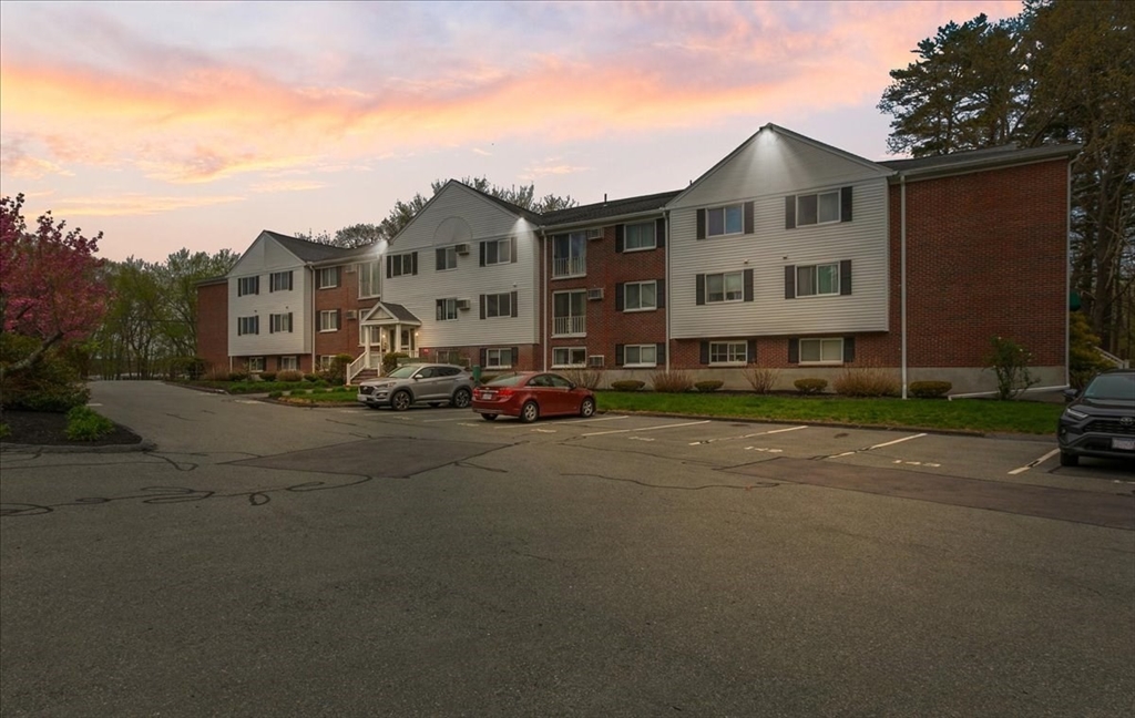 25 Clark's Road, Unit 101 Amesbury, MA 01913 - Photo 4 of 32 a city street lined with buildings and cars