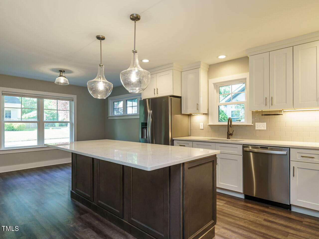 611 Frank Street Raleigh, NC 27604 - Photo 5 of 30 a kitchen with stainless steel appliances granite countertop a sink a stove a refrigerator and island with wooden floor
