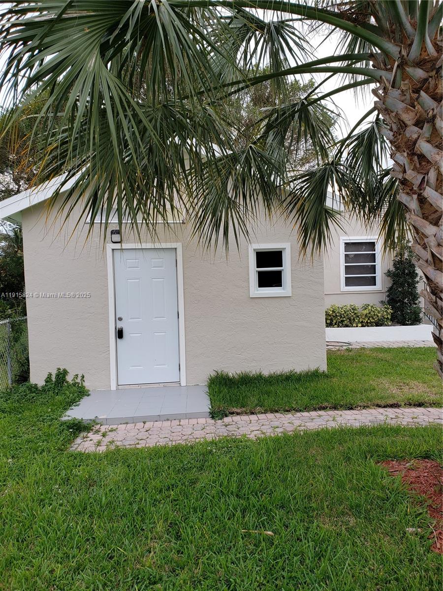 2140 Southwest 25th Street, Unit A Miami, FL 33133 - Photo 1 of 8 a front view of a house with a garden