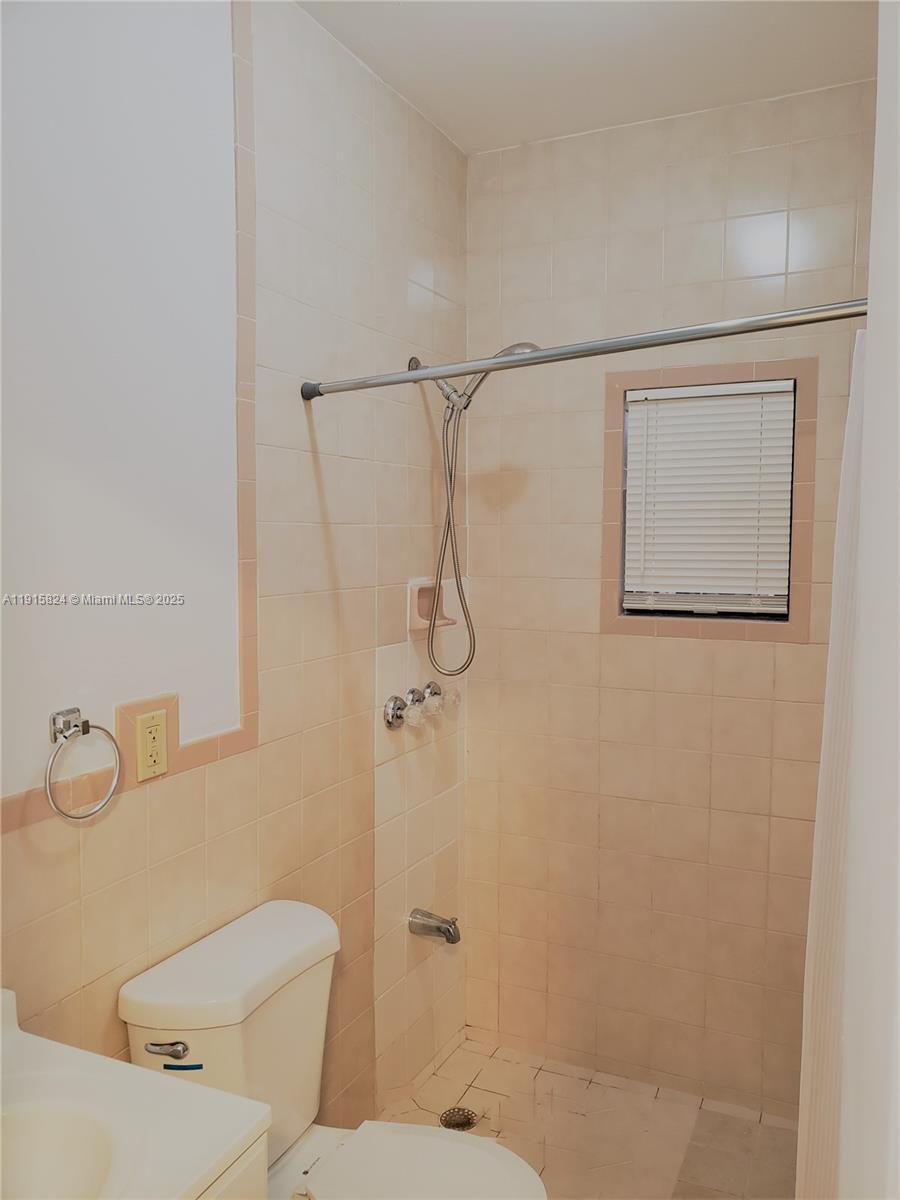 2140 Southwest 25th Street, Unit A Miami, FL 33133 - Photo 4 of 8 a bathroom with a toilet and shower