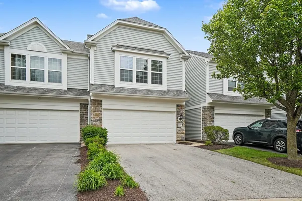 a front view of a house with a yard and garage