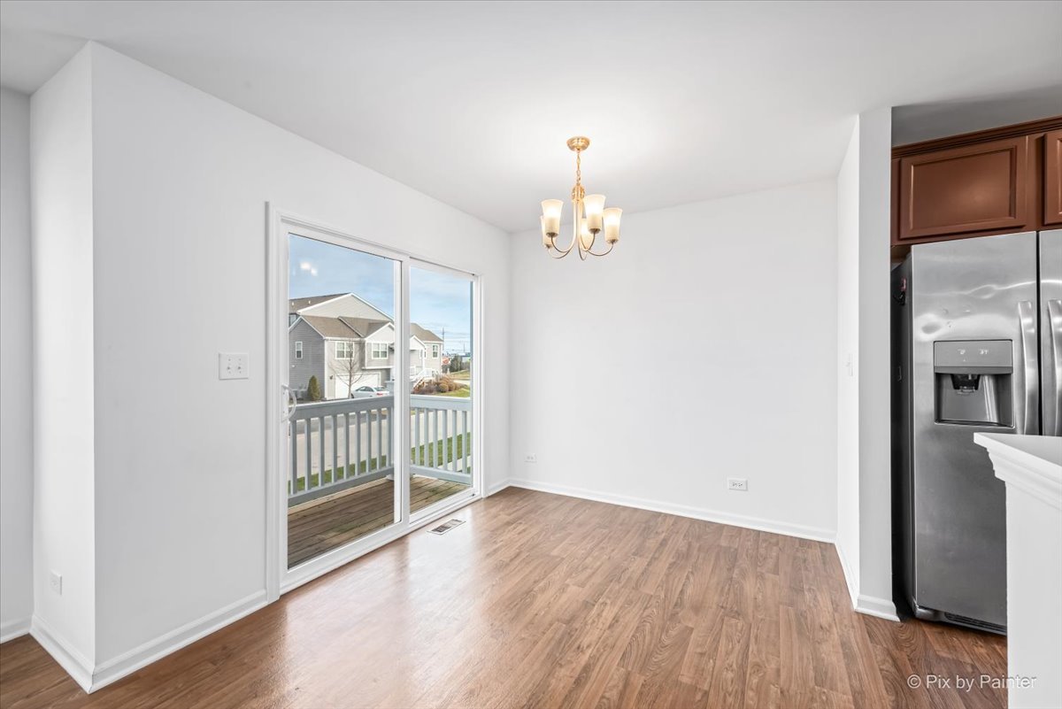 2375 Upland Road Pingree Grove, IL 60140 - Photo 8 of 32 wooden floor in an empty room with a window