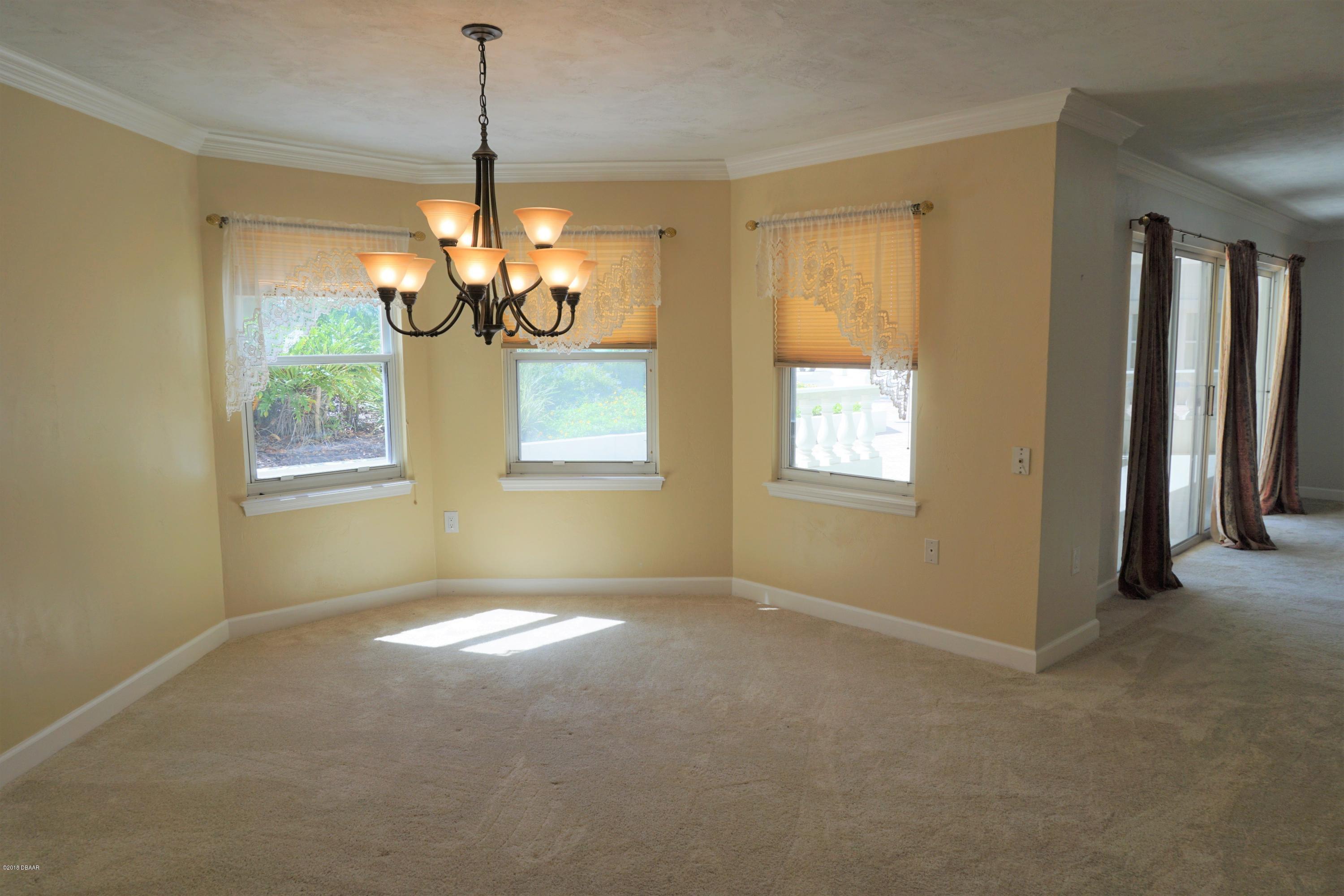 1 John Anderson Drive, Unit 113 Ormond Beach, FL 32176 - Photo 12 of 76 a view of a windows and chandelier in a room