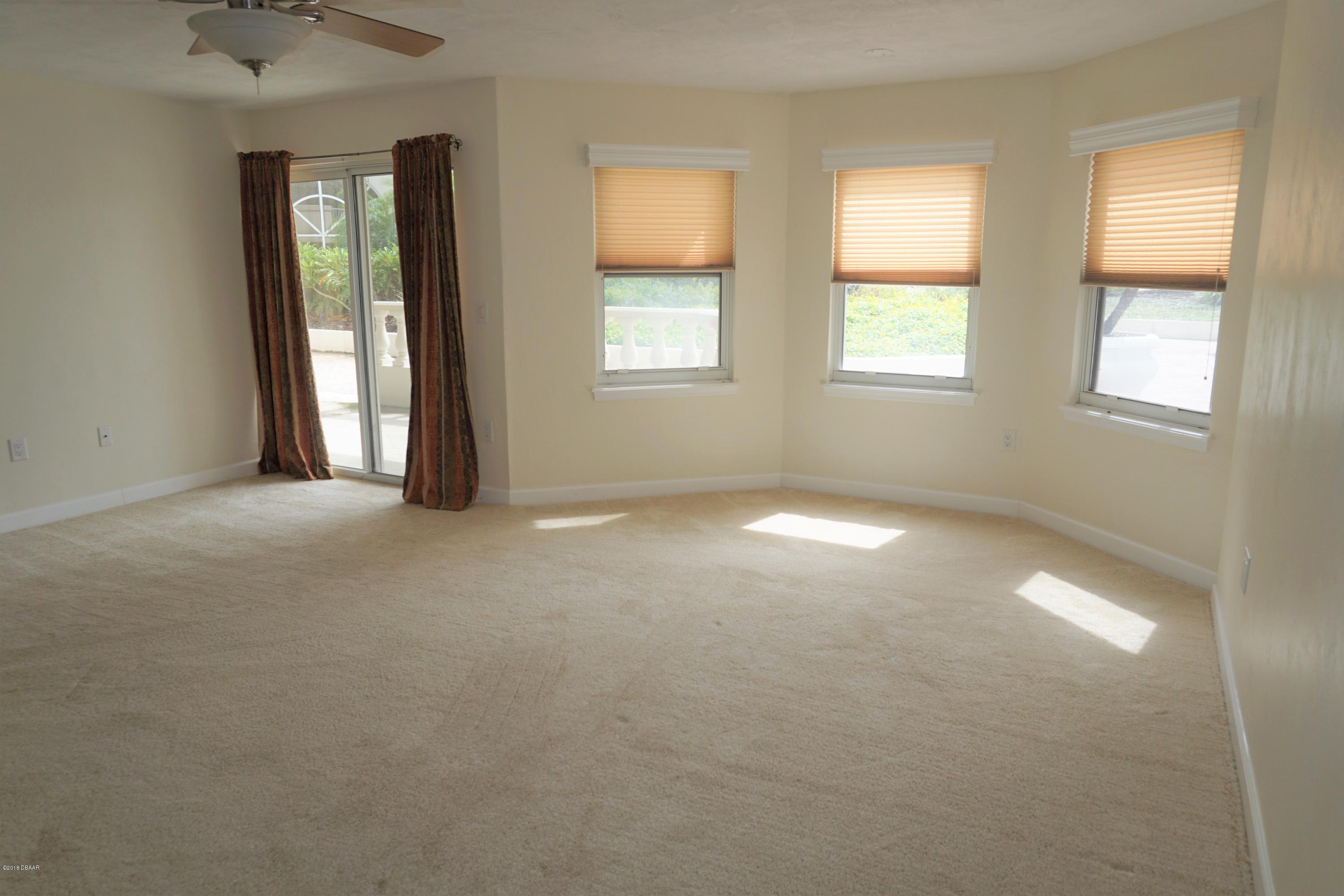 1 John Anderson Drive, Unit 113 Ormond Beach, FL 32176 - Photo 21 of 76 an empty room with windows and closet