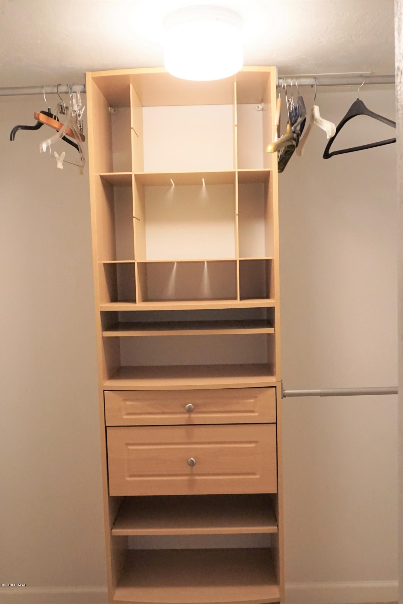 1 John Anderson Drive, Unit 113 Ormond Beach, FL 32176 - Photo 31 of 76 a view of walk in closet with empty racks