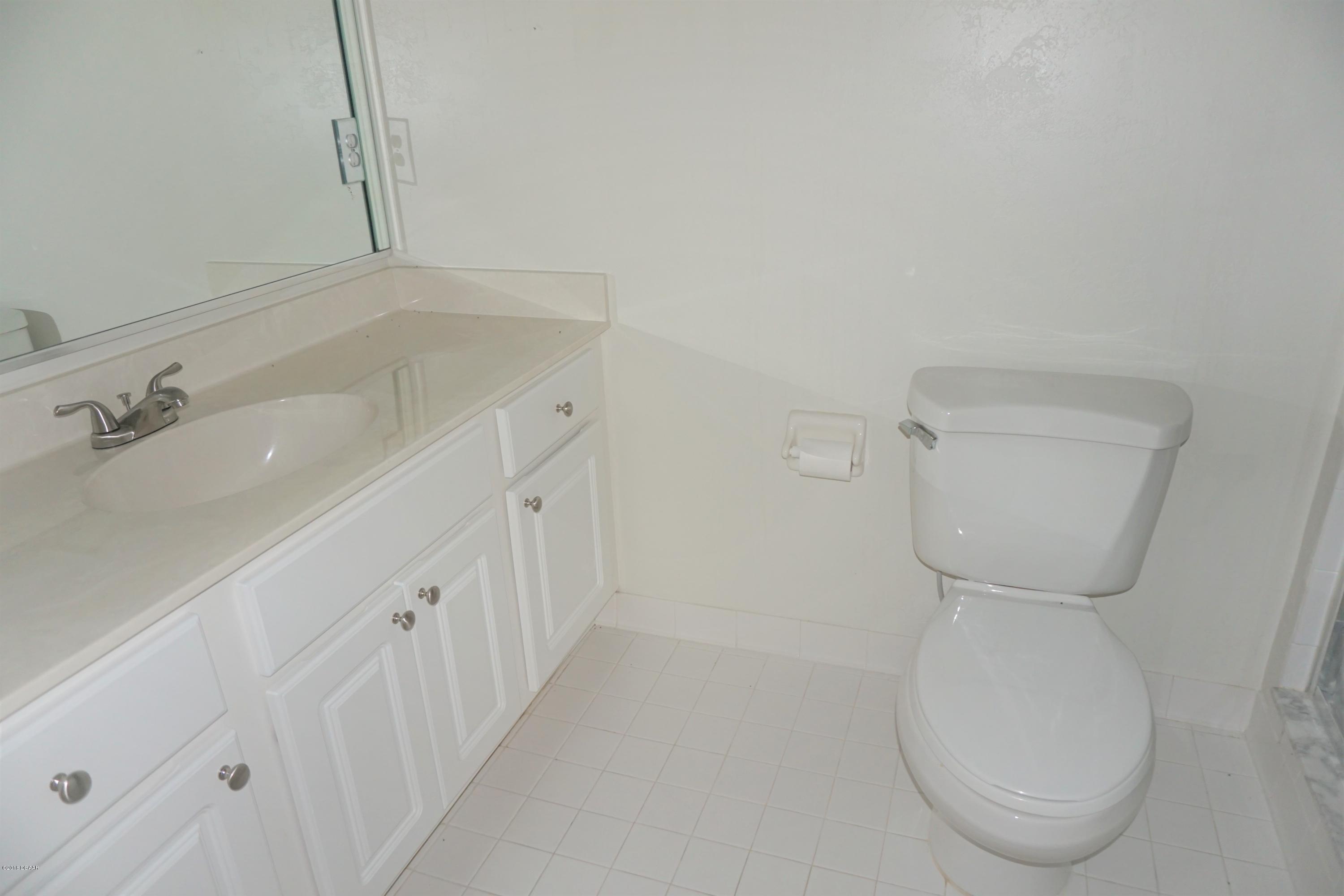 1 John Anderson Drive, Unit 113 Ormond Beach, FL 32176 - Photo 34 of 76 a bathroom with a sink and toilet