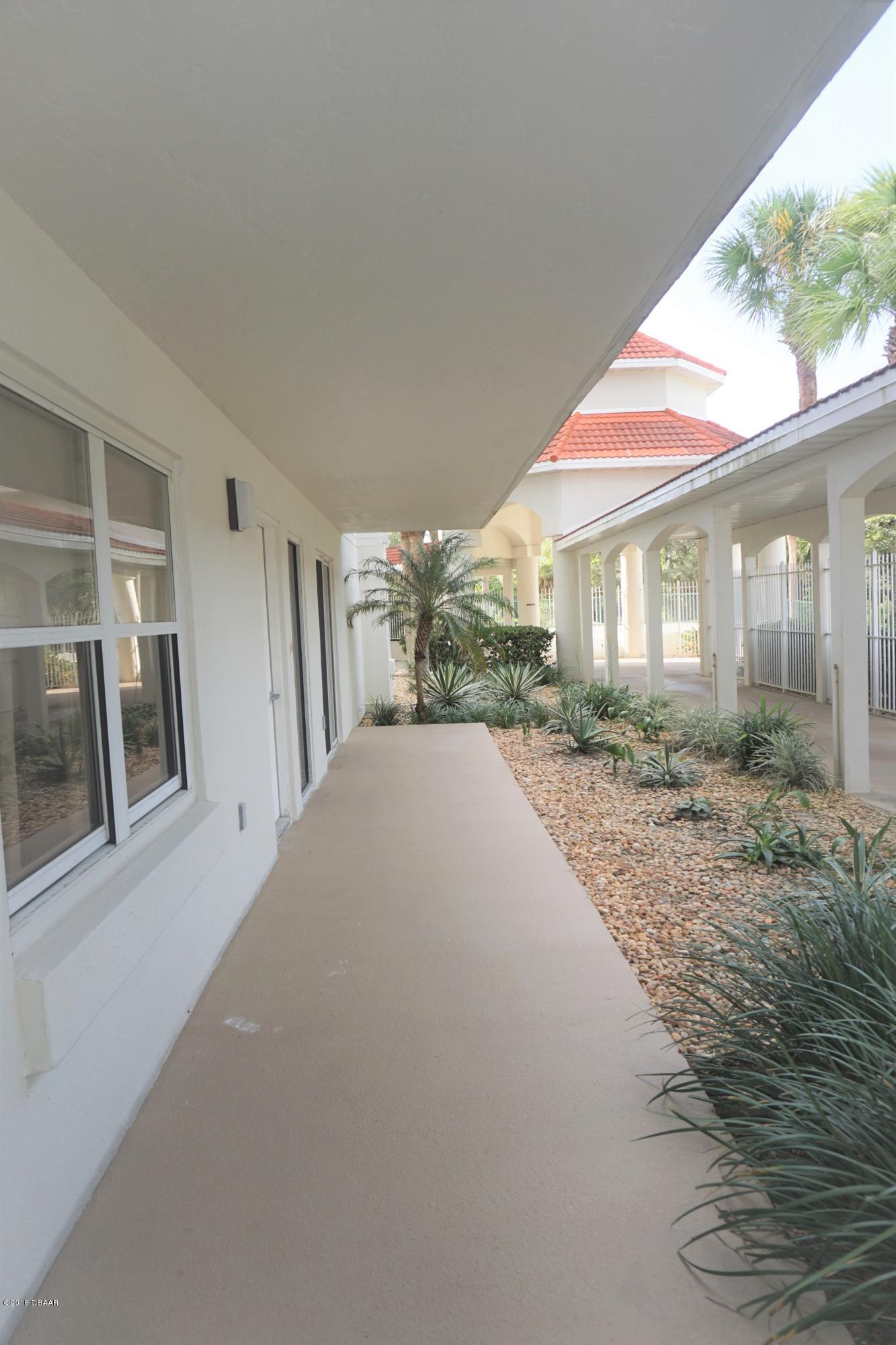 1 John Anderson Drive, Unit 113 Ormond Beach, FL 32176 - Photo 4 of 76 a view of a house with a porch