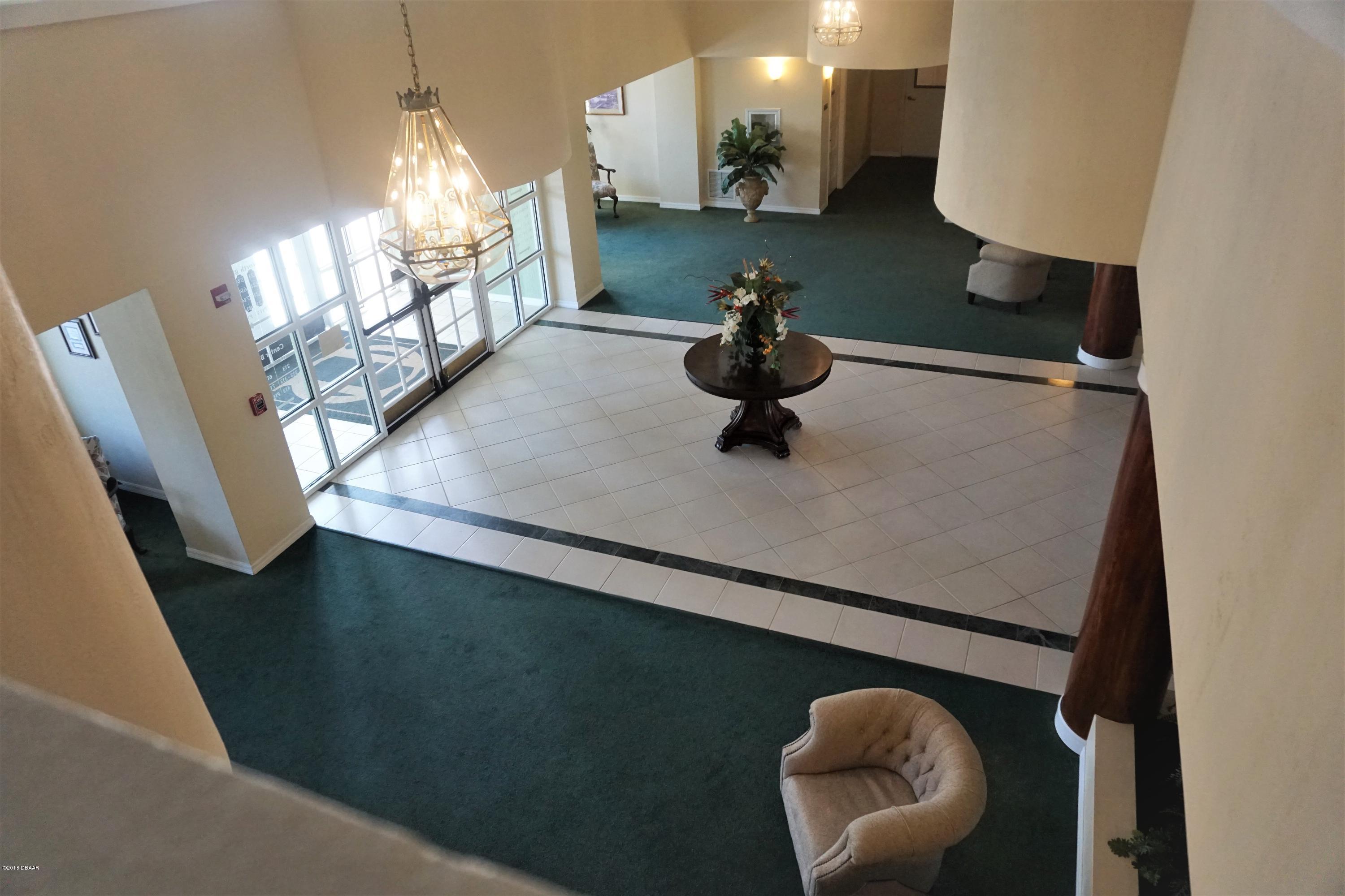 1 John Anderson Drive, Unit 113 Ormond Beach, FL 32176 - Photo 59 of 76 a view of dining room with furniture and wooden floor