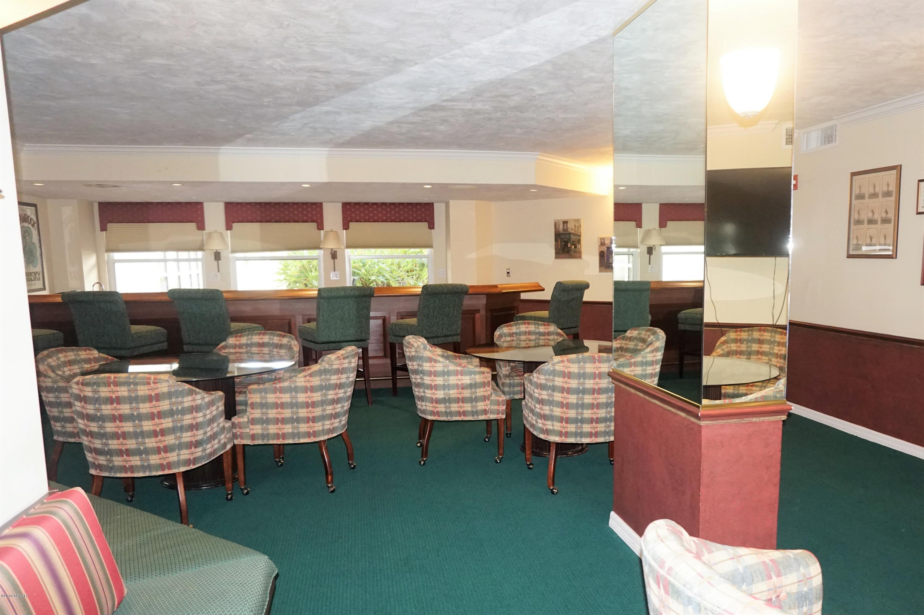 1 John Anderson Drive, Unit 113 Ormond Beach, FL 32176 - Photo 63 of 76 a living room with furniture and a window