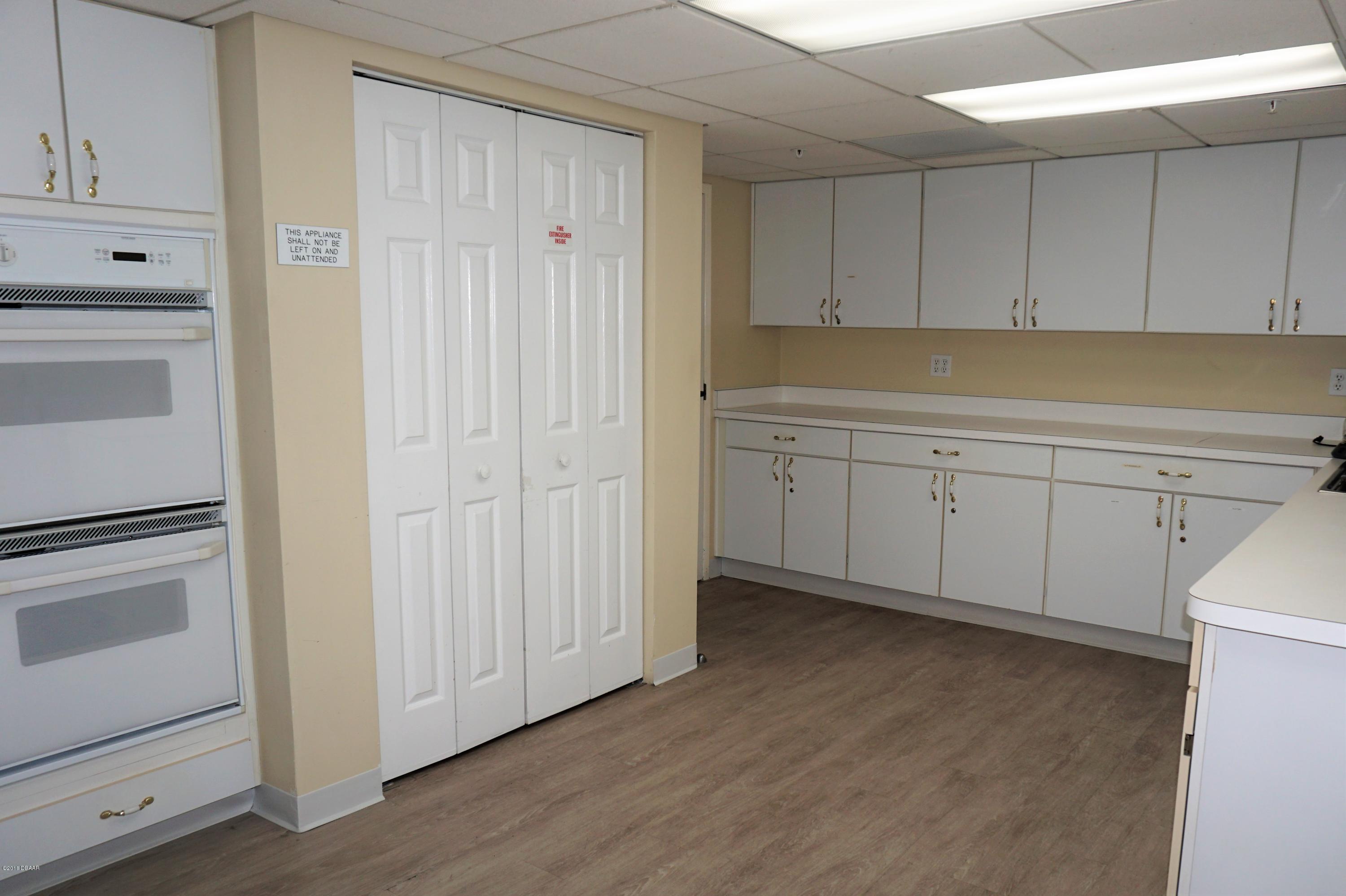 1 John Anderson Drive, Unit 113 Ormond Beach, FL 32176 - Photo 66 of 76 a view of cabinets area with wooden floor