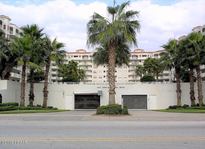 1 John Anderson Drive, Unit 113 Ormond Beach, FL 32176 - Photo 76 of 76 a front view of a house with a garden and palm trees
