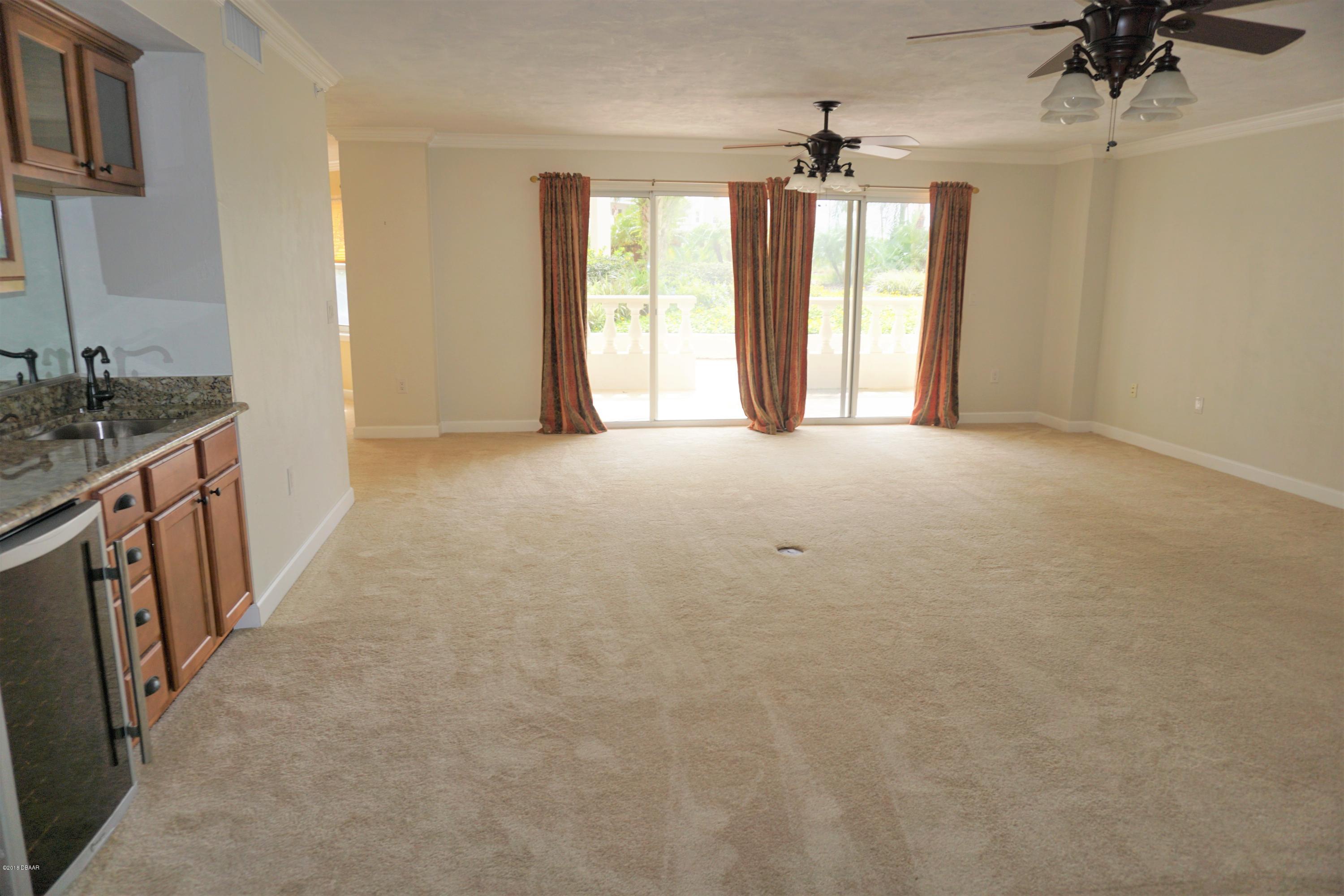1 John Anderson Drive, Unit 113 Ormond Beach, FL 32176 - Photo 9 of 76 wooden floor in an empty room with a window