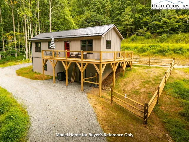 a view of a patio with table and chairs with wooden fence