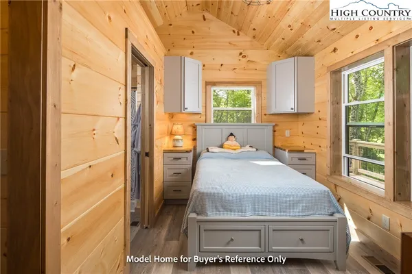 a room with a bed and a window with the outer view