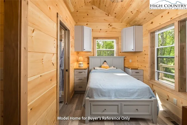 a room with a bed and a window with the outer view