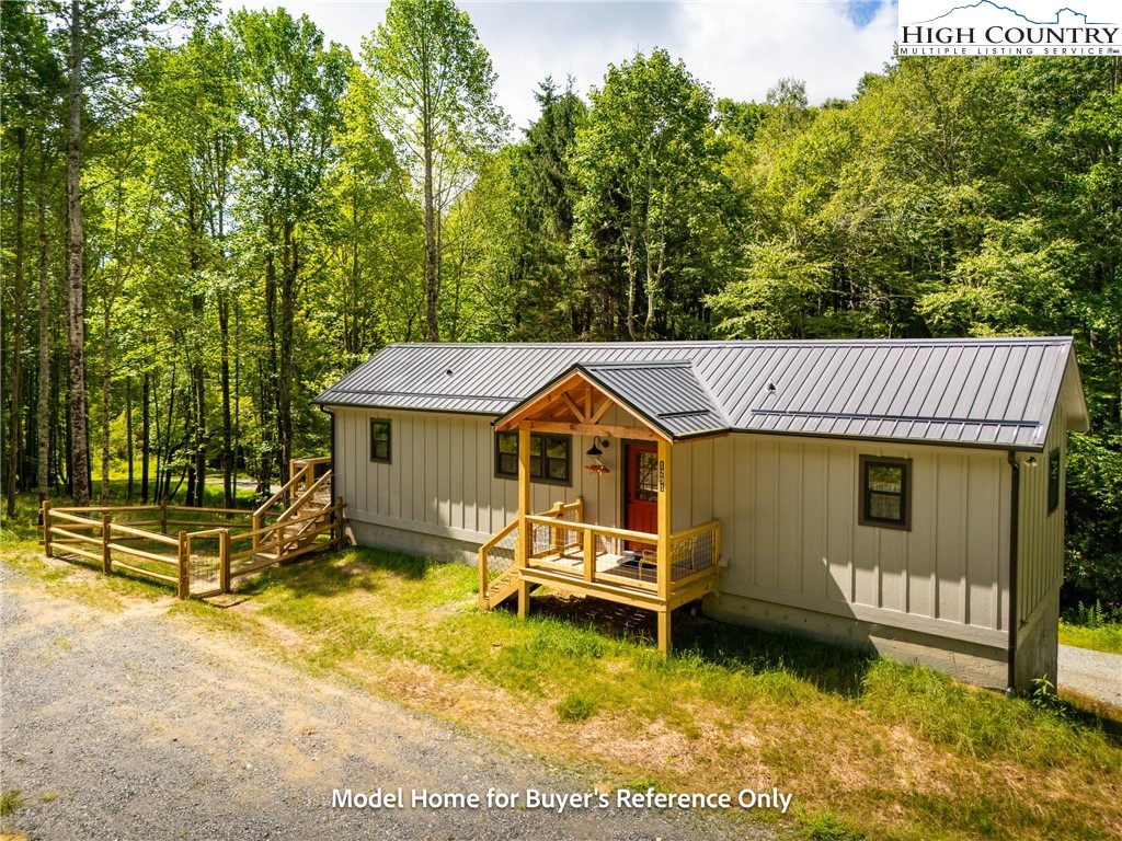 490 Laurelwood Lane Boone, NC 28607 - Photo 13 of 50 a view of a house with a wooden deck and a yard