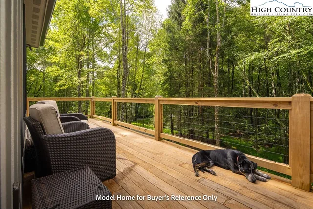 a view of a chair and tables in the balcony