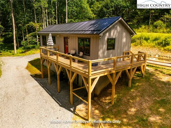 a view of a patio with table and chairs with wooden floor and fence