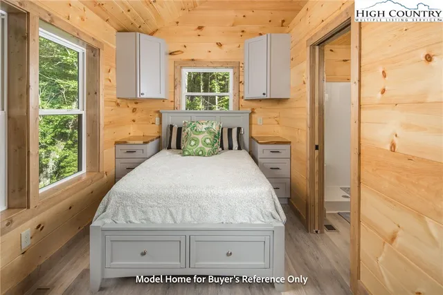 a bathroom with a granite countertop sink a large mirror a shower and a window