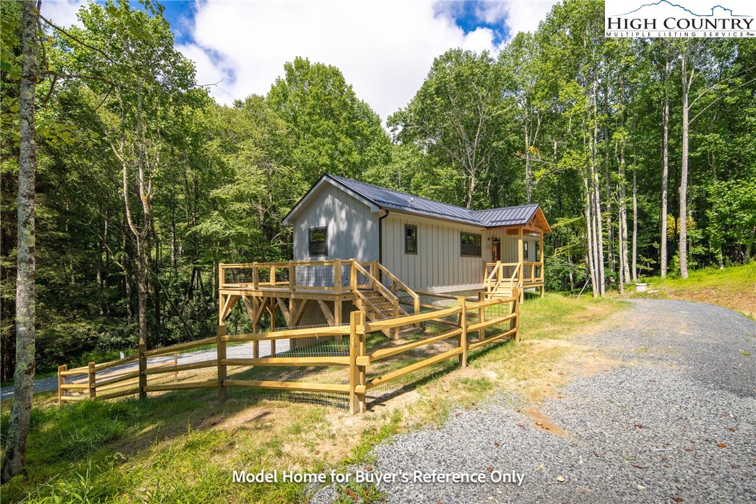 490 Laurelwood Lane Boone, NC 28607 - Photo 33 of 50 a view of a house with backyard and a wooden fence