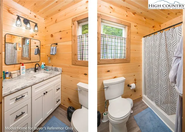 a bathroom with a granite countertop toilet a sink and a large mirror