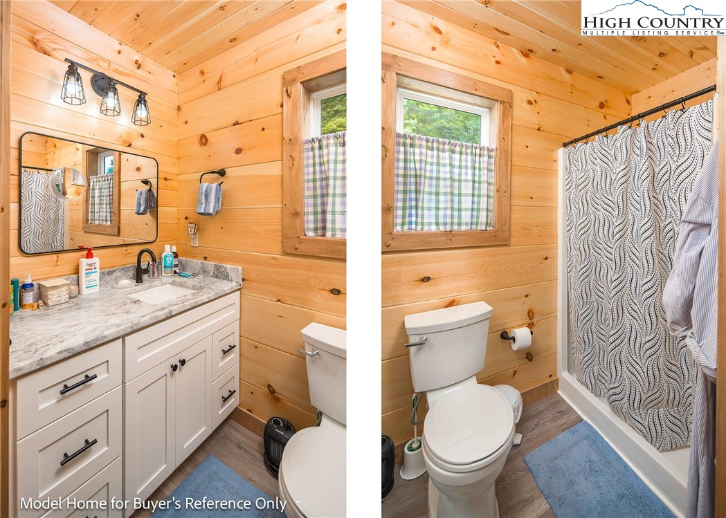 490 Laurelwood Lane Boone, NC 28607 - Photo 37 of 50 a bathroom with a granite countertop toilet a sink and a large mirror