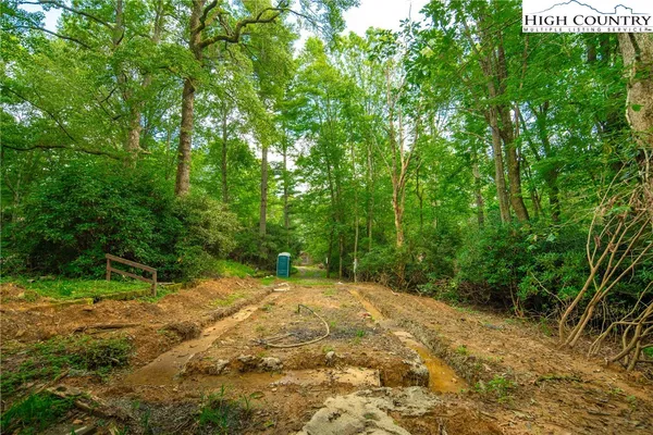 a view of a field with trees in the background