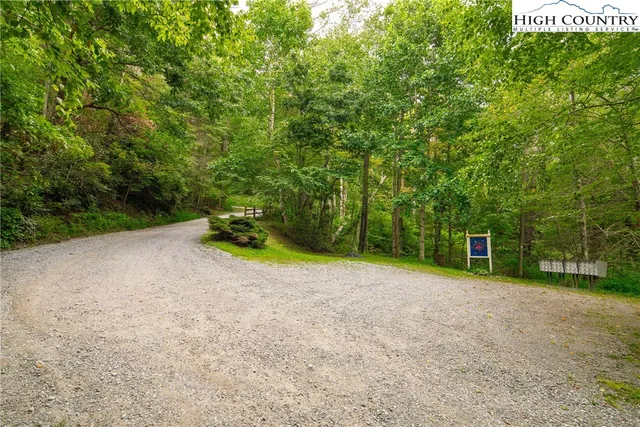 a sign that is sitting in the middle of a forest