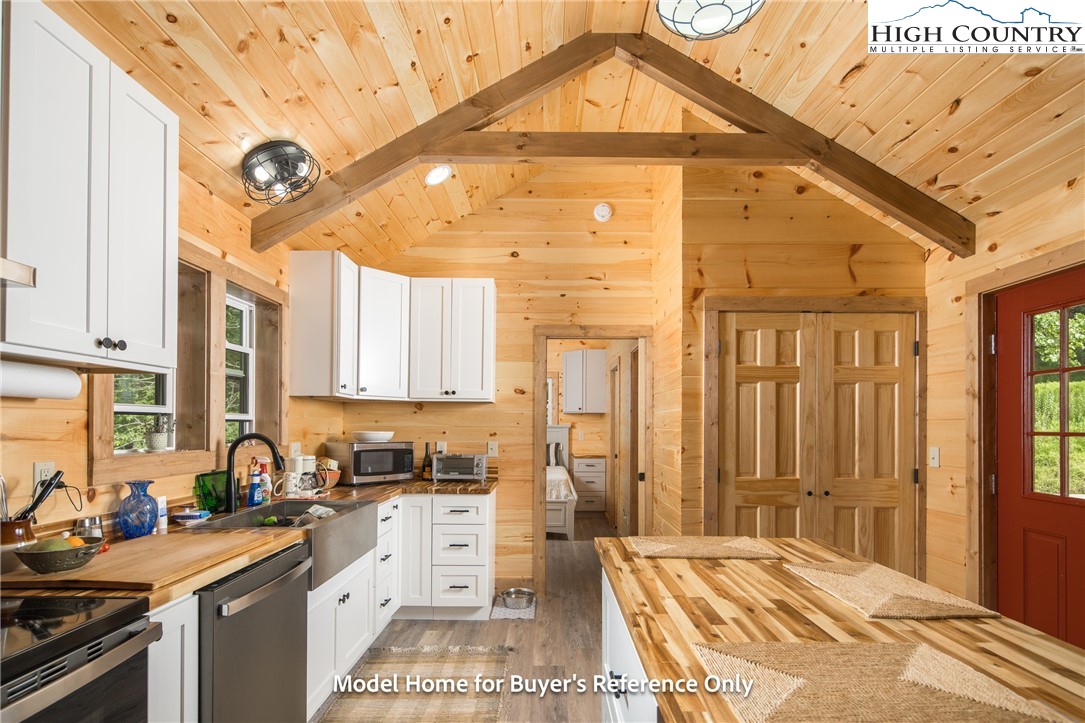 490 Laurelwood Lane Boone, NC 28607 - Photo 5 of 50 a kitchen with stainless steel appliances a stove a sink dishwasher and cabinets with wooden floor