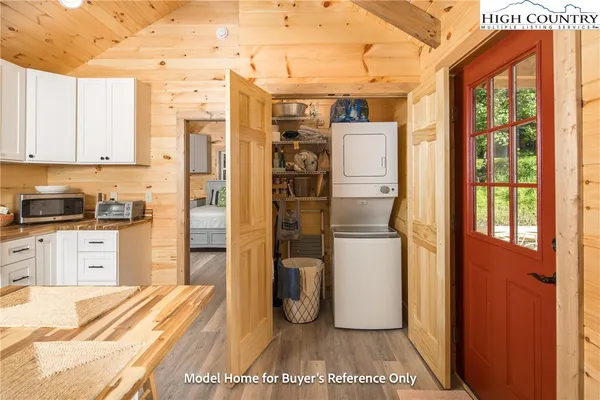 a kitchen with a refrigerator and white cabinets