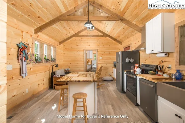 a kitchen with a sink a stove and a refrigerator