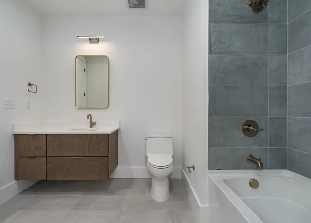 a bathroom with a sink a toilet and bathtub