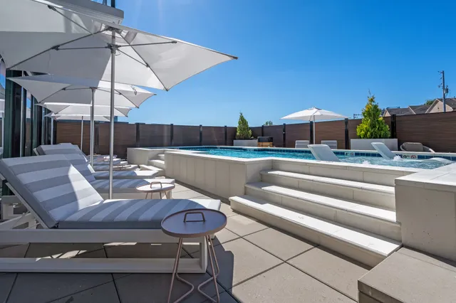 a view of table and chairs under an umbrella