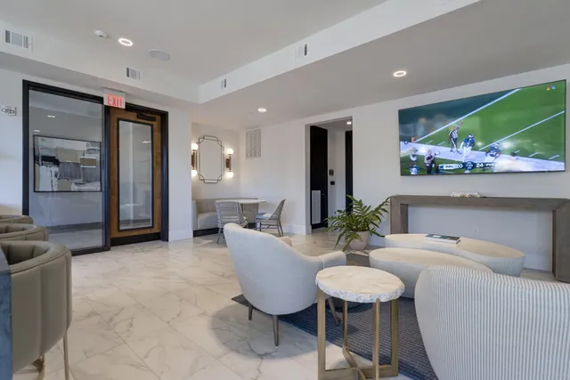 a large kitchen with kitchen island a counter space a sink and a large window