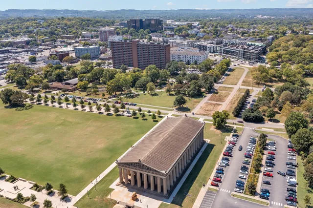 an aerial view of a residential apartment building with a yard