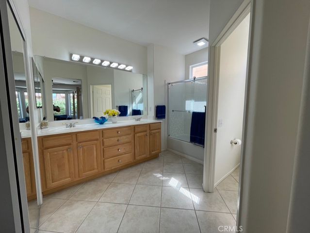 a large bathroom with a double vanity sink and a mirror