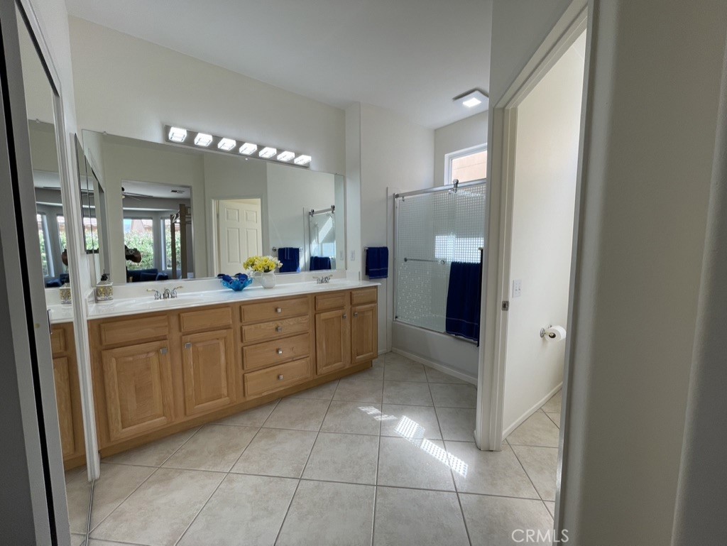 35330 Rosemont Drive Palm Desert, CA 92211 - Photo 12 of 38 a large bathroom with a double vanity sink and a mirror