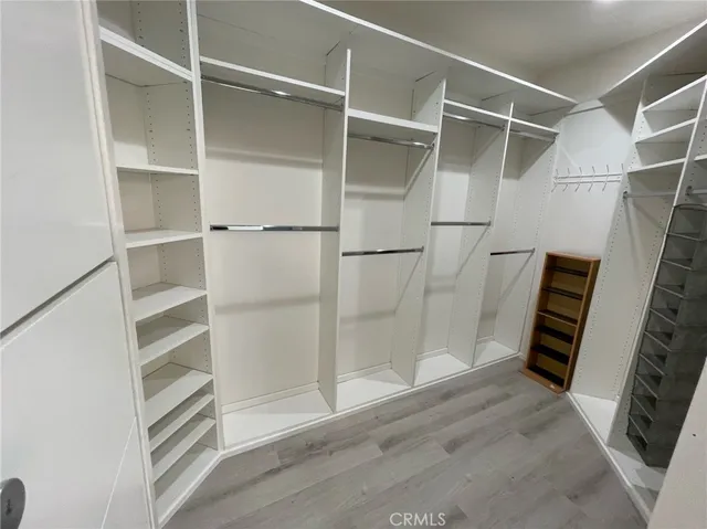 a view of walk in closet with empty racks