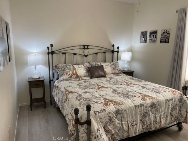 a bedroom with a bed and a night stand