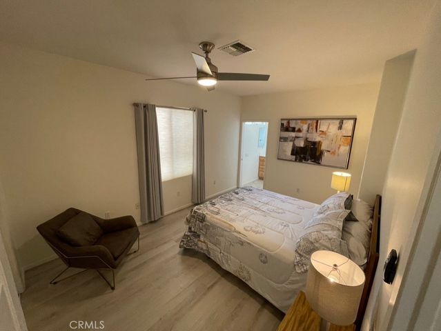 a bed room with a bed and a chair